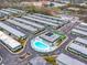 Overhead community view featuring a pool, tennis court, and adjacent, well-maintained apartment homes at 7816 38Th N Ter # 7816, St Petersburg, FL 33709