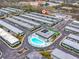 Overhead community view featuring a pool, tennis court, and adjacent, well-maintained apartment homes at 7816 38Th N Ter # 7816, St Petersburg, FL 33709
