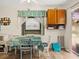 Dining room area features a ceiling fan, green table setting, and neutral paint at 7816 38Th N Ter # 7816, St Petersburg, FL 33709