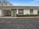 Charming single-story home featuring a green door and well-maintained front yard landscaping at 7816 38Th N Ter # 7816, St Petersburg, FL 33709