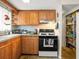 Galley kitchen features wooden cabinets, tile floors, and a view of a walk-in pantry at 7816 38Th N Ter # 7816, St Petersburg, FL 33709