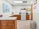 Kitchen with lots of storage, granite countertops, white refrigerator and light tile flooring at 7816 38Th N Ter # 7816, St Petersburg, FL 33709