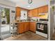 Galley kitchen features wooden cabinets, a stainless steel cart, tile floors, and an exterior exit at 7816 38Th N Ter # 7816, St Petersburg, FL 33709