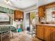 Kitchen includes dining space, wooden cabinets, stainless steel cart, and tile floors at 7816 38Th N Ter # 7816, St Petersburg, FL 33709