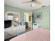 Bedroom featuring dresser with a mirror, green walls, and light carpet at 7816 38Th N Ter # 7816, St Petersburg, FL 33709
