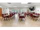 Bright meeting room with tables and chairs plus views of outdoor seating and other buildings at 7816 38Th N Ter # 7816, St Petersburg, FL 33709