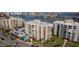 Aerial of condo buildings, parking lot, pool, and waterway in Clearwater Point at 830 S Gulfview Blvd # 501, Clearwater Beach, FL 33767