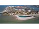 Stunning aerial view of condo complex with pool, tennis courts, beach, and bay at 830 S Gulfview Blvd # 501, Clearwater Beach, FL 33767