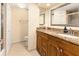 Bathroom with granite counters, wooden cabinetry, and tiled floors at 830 S Gulfview Blvd # 501, Clearwater Beach, FL 33767