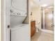 Well-lit bathroom featuring a stacked washer/dryer and glass-door shower at 830 S Gulfview Blvd # 501, Clearwater Beach, FL 33767