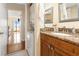 Granite-topped vanity in bathroom with a stacked washer and dryer at 830 S Gulfview Blvd # 501, Clearwater Beach, FL 33767