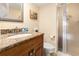 Bathroom with vanity, granite countertop, shower, toilet, and decorative mirror at 830 S Gulfview Blvd # 501, Clearwater Beach, FL 33767