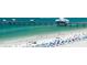 Vibrant beach scene with clear turquoise water, white sand, and a bustling crowd of beachgoers and umbrellas at 830 S Gulfview Blvd # 501, Clearwater Beach, FL 33767