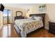 Relaxing bedroom with hardwood floors, dresser, nightstand, and balcony access at 830 S Gulfview Blvd # 501, Clearwater Beach, FL 33767