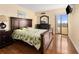 Bedroom with dark wood floors, balcony access, and matching furniture at 830 S Gulfview Blvd # 501, Clearwater Beach, FL 33767