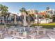 Exterior shot of community tables and umbrellas with condos in the background at 830 S Gulfview Blvd # 501, Clearwater Beach, FL 33767