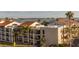 View of condo buildings showcasing red-tiled roofs and palm trees at 830 S Gulfview Blvd # 501, Clearwater Beach, FL 33767