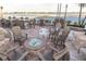 Community area with a fire pit, waterfront views, and ample seating; ideal for relaxing outdoors at 830 S Gulfview Blvd # 501, Clearwater Beach, FL 33767