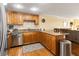 Cozy kitchen featuring wooden cabinets, stainless steel appliances, and granite countertops at 830 S Gulfview Blvd # 501, Clearwater Beach, FL 33767