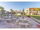 Inviting outdoor seating area with multiple tables, benches, umbrellas, and well-maintained landscaping at 830 S Gulfview Blvd # 501, Clearwater Beach, FL 33767