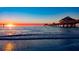 Stunning waterfront view features a pier at sunset with colorful skies at 830 S Gulfview Blvd # 501, Clearwater Beach, FL 33767