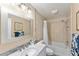 Bathroom boasts tiled shower/tub, a stylish vanity, and ample lighting at 908 Evelyn Ave, Clearwater, FL 33764