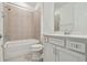 Bathroom has white cabinets, tile floor, and shower and bath combo at 9412 Coastline Way, Parrish, FL 34219