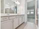 Bathroom features double vanity with grey cabinets, quartz countertops and tile flooring at 9412 Coastline Way, Parrish, FL 34219