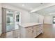 Kitchen island with drawers and cabinet space, and stainless-steel appliances in view from the open floor plan at 9412 Coastline Way, Parrish, FL 34219