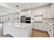 Well-lit kitchen featuring white cabinets, stainless steel appliances, subway tile backsplash, and a center island at 9412 Coastline Way, Parrish, FL 34219