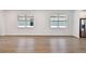 Open living area with plank flooring and large windows, seamlessly flowing into the modern kitchen at 9412 Coastline Way, Parrish, FL 34219