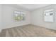Cozy bedroom with neutral carpet and two windows providing natural light at 9466 Shorebird Ct, Parrish, FL 34219