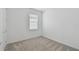 Neutral bedroom with carpet and a single window, providing a serene space at 9466 Shorebird Ct, Parrish, FL 34219