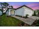 Charming home featuring a beautifully landscaped yard, brick walkway, and attached two-car garage at 9466 Shorebird Ct, Parrish, FL 34219