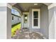 Covered entry with light-blue door, gray walls, brick pavers and window at 9466 Shorebird Ct, Parrish, FL 34219