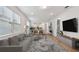 Bright living room boasts hardwood floors, modern furnishings, and an open concept floorplan at 9466 Shorebird Ct, Parrish, FL 34219