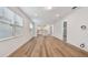 Bright living room featuring wood floors and an open concept design with a view of the kitchen at 9466 Shorebird Ct, Parrish, FL 34219