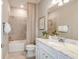 Bright bathroom features a tub with tiled surround and a vanity with a marble countertop at 9470 Shorebird Ct, Parrish, FL 34219