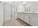 Bathroom featuring a double vanity, tiled floors, and glass-enclosed shower at 9470 Shorebird Ct, Parrish, FL 34219