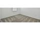 Neutral bedroom features a carpeted floor, natural light, and fresh white paint at 9470 Shorebird Ct, Parrish, FL 34219