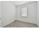 Bedroom with neutral tone paint, wood-look floors, and natural light from the window at 9470 Shorebird Ct, Parrish, FL 34219