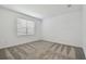 Clean bedroom with neutral carpeting and a window providing natural light at 9470 Shorebird Ct, Parrish, FL 34219