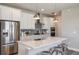 Well-equipped kitchen boasts stainless steel appliances, white cabinets, and an island with barstool seating at 9470 Shorebird Ct, Parrish, FL 34219