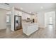 Open kitchen with stainless steel appliances, white cabinets, and a central island at 9470 Shorebird Ct, Parrish, FL 34219