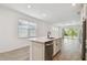 Kitchen with large island, stainless steel appliances, and an open layout leading to the living room at 9470 Shorebird Ct, Parrish, FL 34219