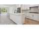 Well-lit kitchen featuring a central island, stainless appliances, and seamless access to the outdoors at 9470 Shorebird Ct, Parrish, FL 34219