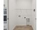 A clean and simple laundry room area with hookups and space for appliances at 9470 Shorebird Ct, Parrish, FL 34219