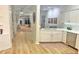 Bright kitchen with a view into the living room, featuring white cabinetry and stainless steel appliances at 1050 Starkey Rd # 106, Largo, FL 33771