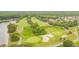 Panoramic aerial view of the golf course with greens, sand traps, and surrounding woodlands at 10620 Tavistock Dr, Tampa, FL 33626