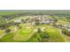 Aerial view of a golf course, pond, community, and lush landscaping in a serene setting at 10620 Tavistock Dr, Tampa, FL 33626